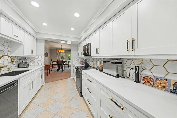 a kitchen with stainless steel appliances granite countertop a sink and cabinets