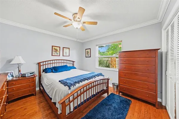 a bedroom with a bed a dresser and a window