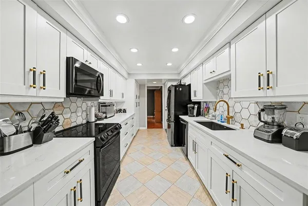a kitchen with refrigerator a sink and cabinets