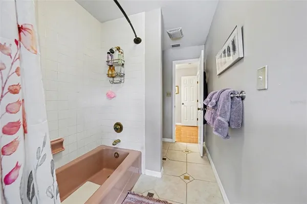 a bathroom with a bathtub and shower curtain