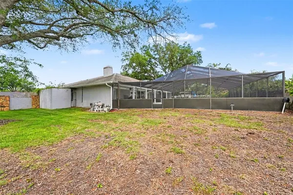 a view of a house with a backyard