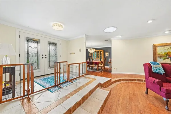 a spacious bedroom with a bed and glass windows