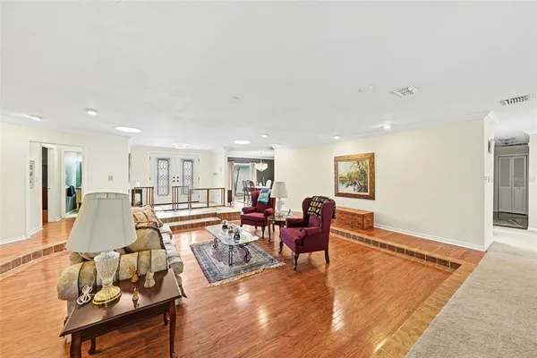 a living room with furniture wooden floor and a table