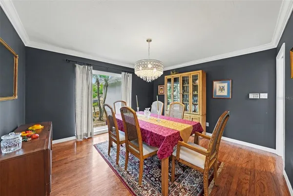 a dining room with furniture a rug and wooden floor