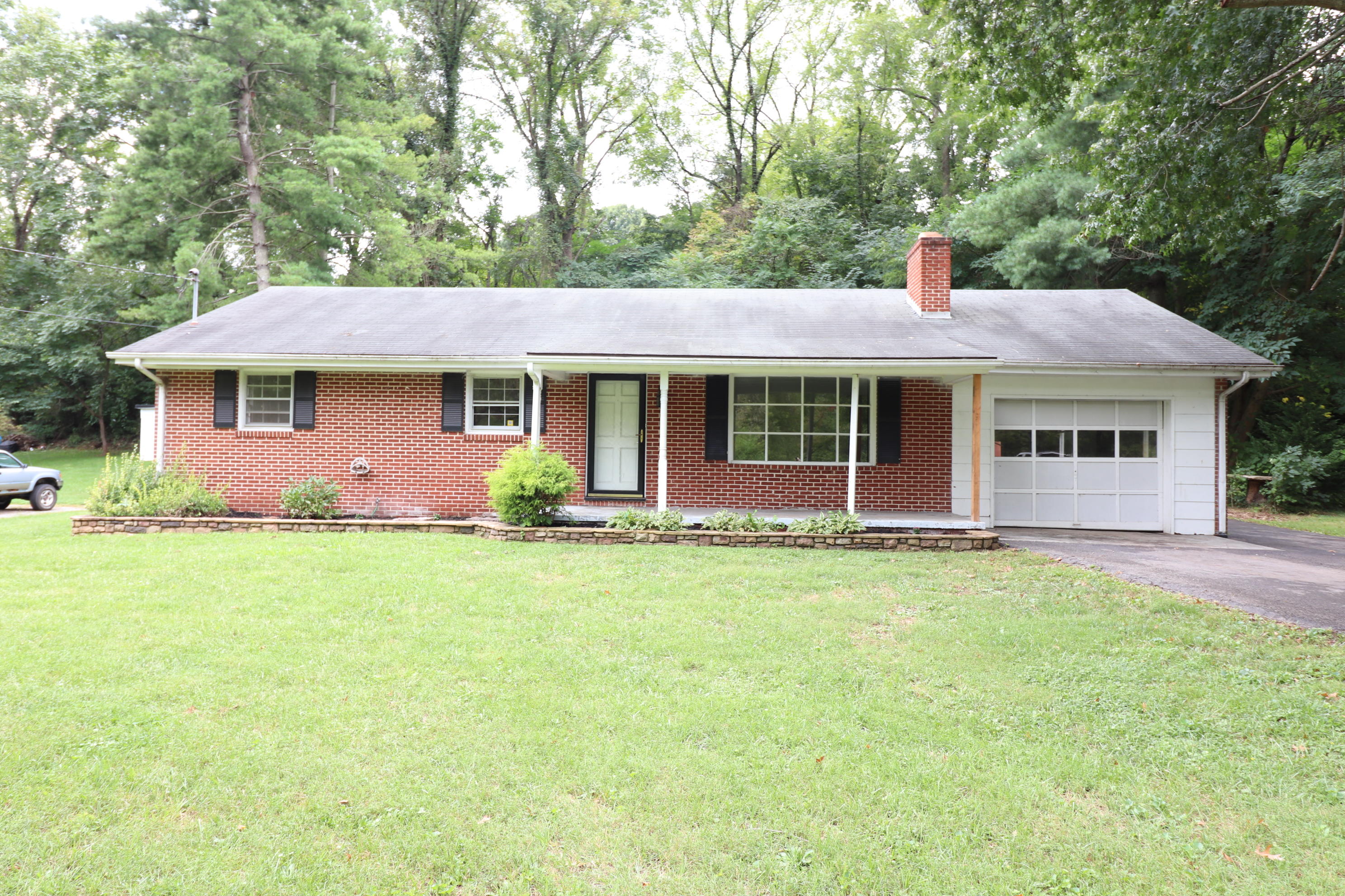 5501 Lafayette Road Elliston, VA 24087 - Photo 1 of 18 a front view of a house with a garden