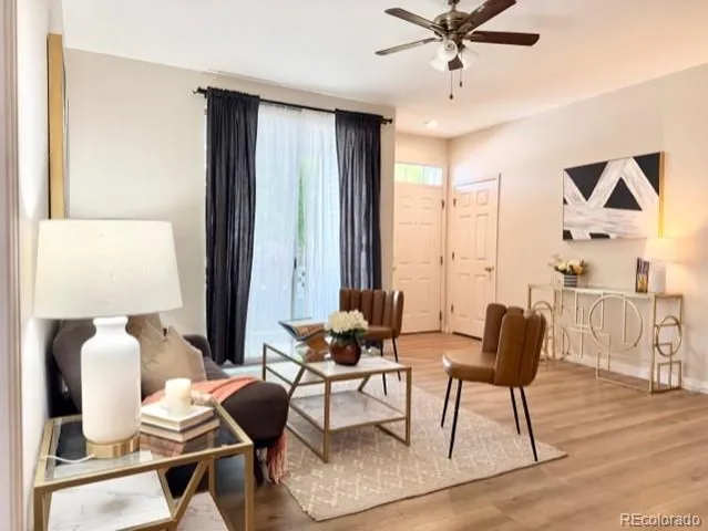 a living room with furniture and wooden floor
