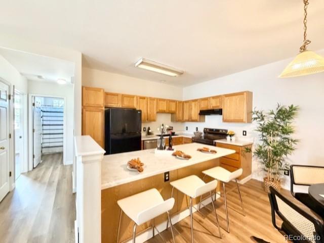 12931 Lafayette Street, Unit G Thornton, CO 80241 - Photo 3 of 21 a living room with furniture and a wooden floor