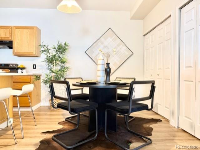 12931 Lafayette Street, Unit G Thornton, CO 80241 - Photo 5 of 21 a view of a dining room with furniture and wooden floor