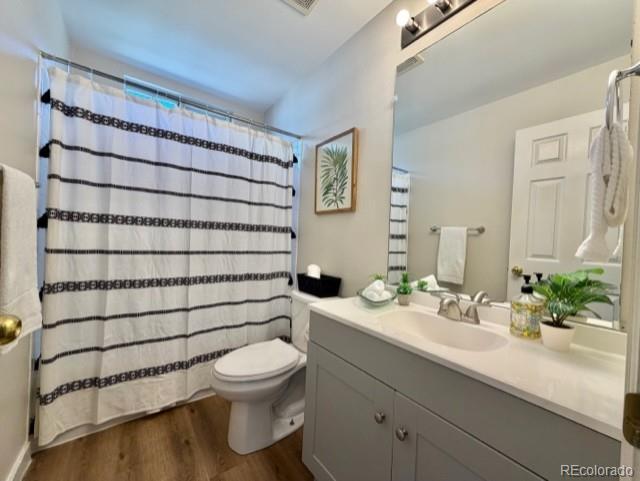 12931 Lafayette Street, Unit G Thornton, CO 80241 - Photo 7 of 21 a bathroom with a sink toilet and shower