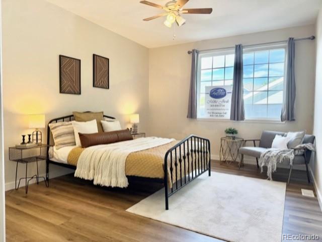 12931 Lafayette Street, Unit G Thornton, CO 80241 - Photo 8 of 21 a bedroom with two beds and a large window