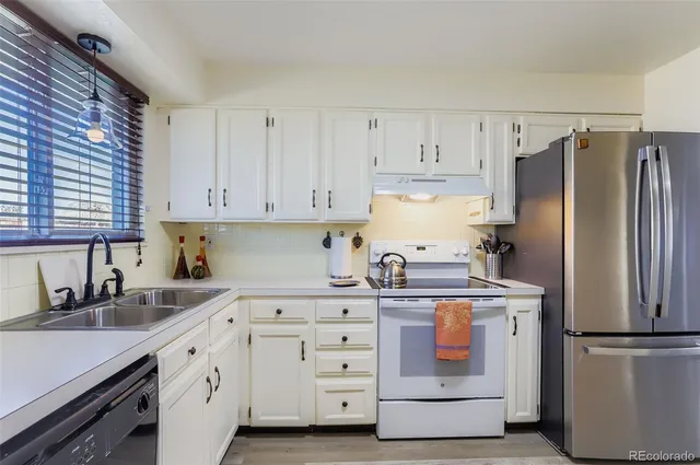 a kitchen with cabinets stainless steel appliances and a sink
