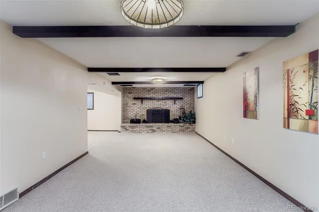 a view of empty room with a fireplace