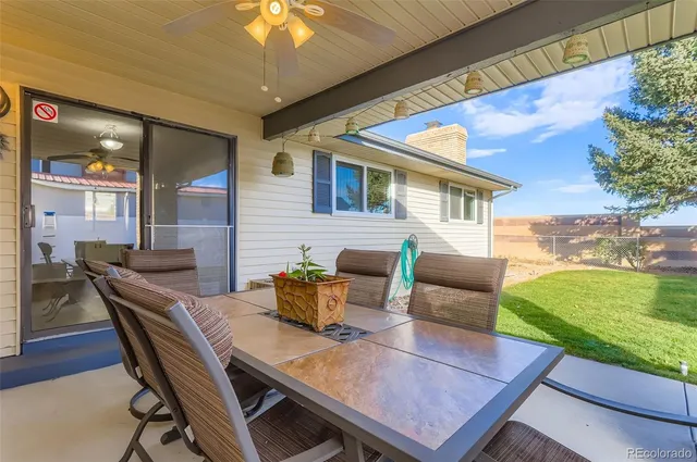 a view of a house with a yard and sitting area