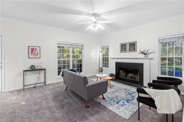 a living room with furniture potted plant and a window