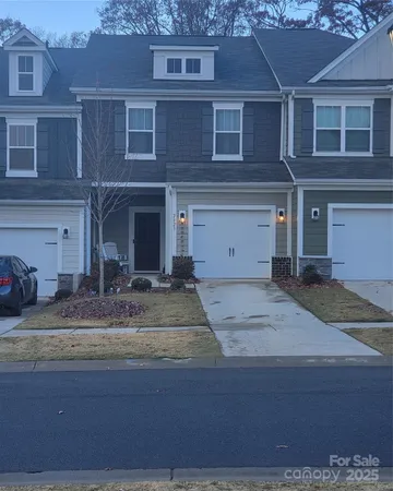 a view of a house with a yard and garage