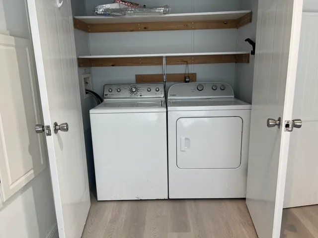 a kitchen with stainless steel appliances a refrigerator and microwave