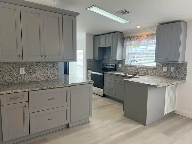 a kitchen with cabinets and chandelier