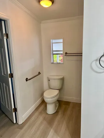 a view of yellow house with a patio