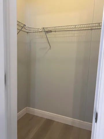 a kitchen with kitchen island granite countertop a sink cabinets and stainless steel appliances