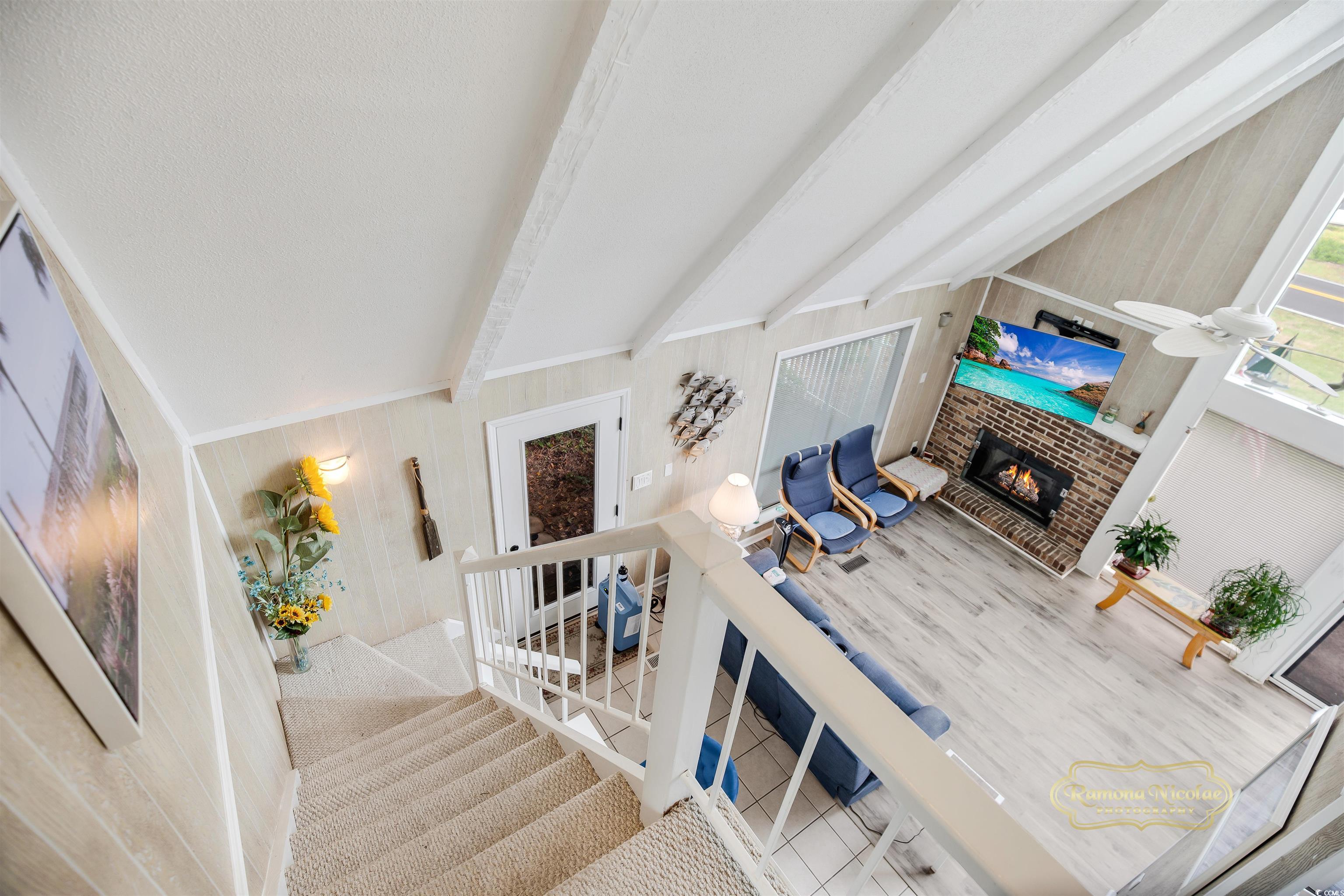 617 3rd Avenue South Surfside Beach, SC 29575 - Photo 12 of 36 Living room with a brick fireplace, beamed ceiling
