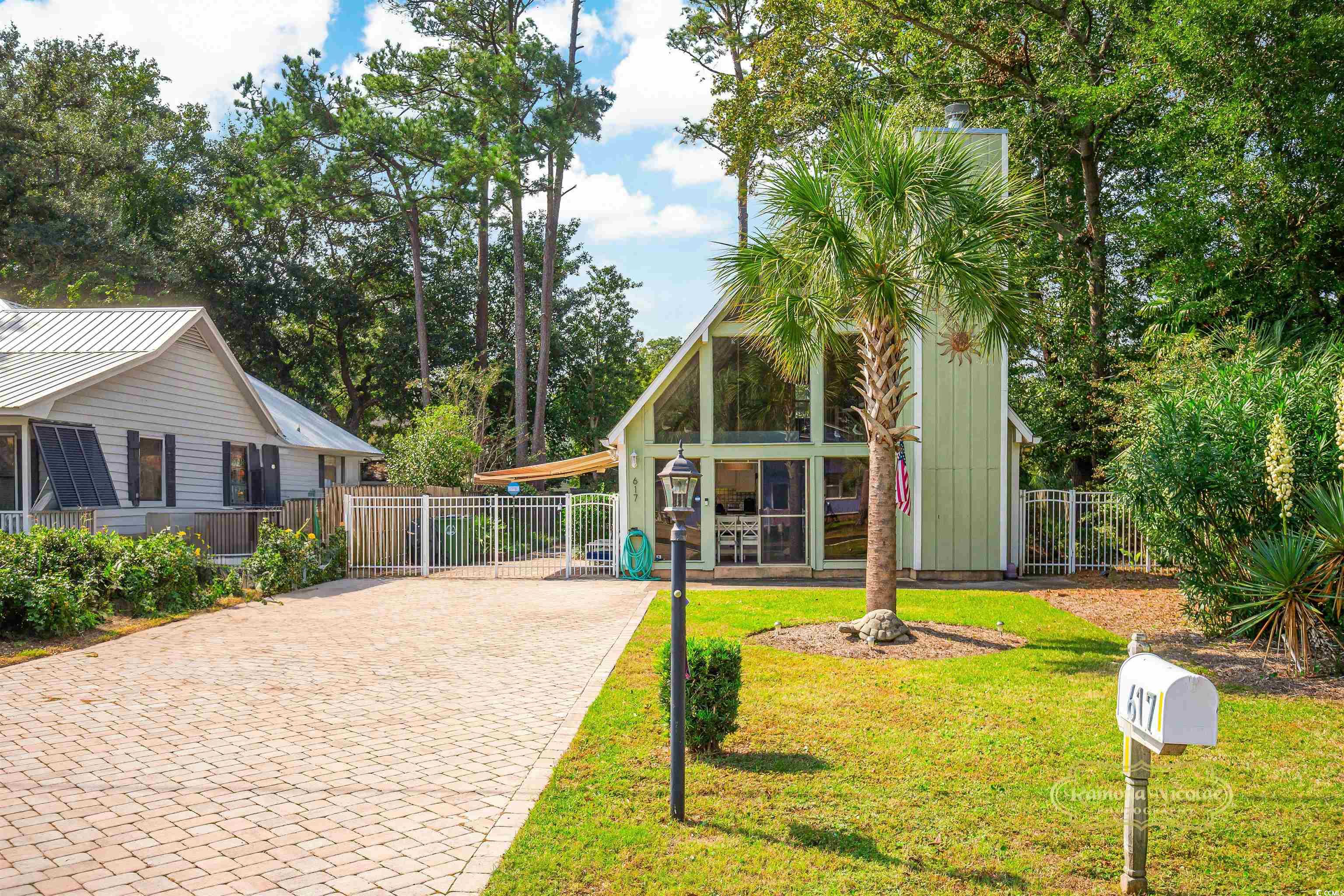 617 3rd Avenue South Surfside Beach, SC 29575 - Photo 3 of 36 Exterior space with decorative driveway and fence
