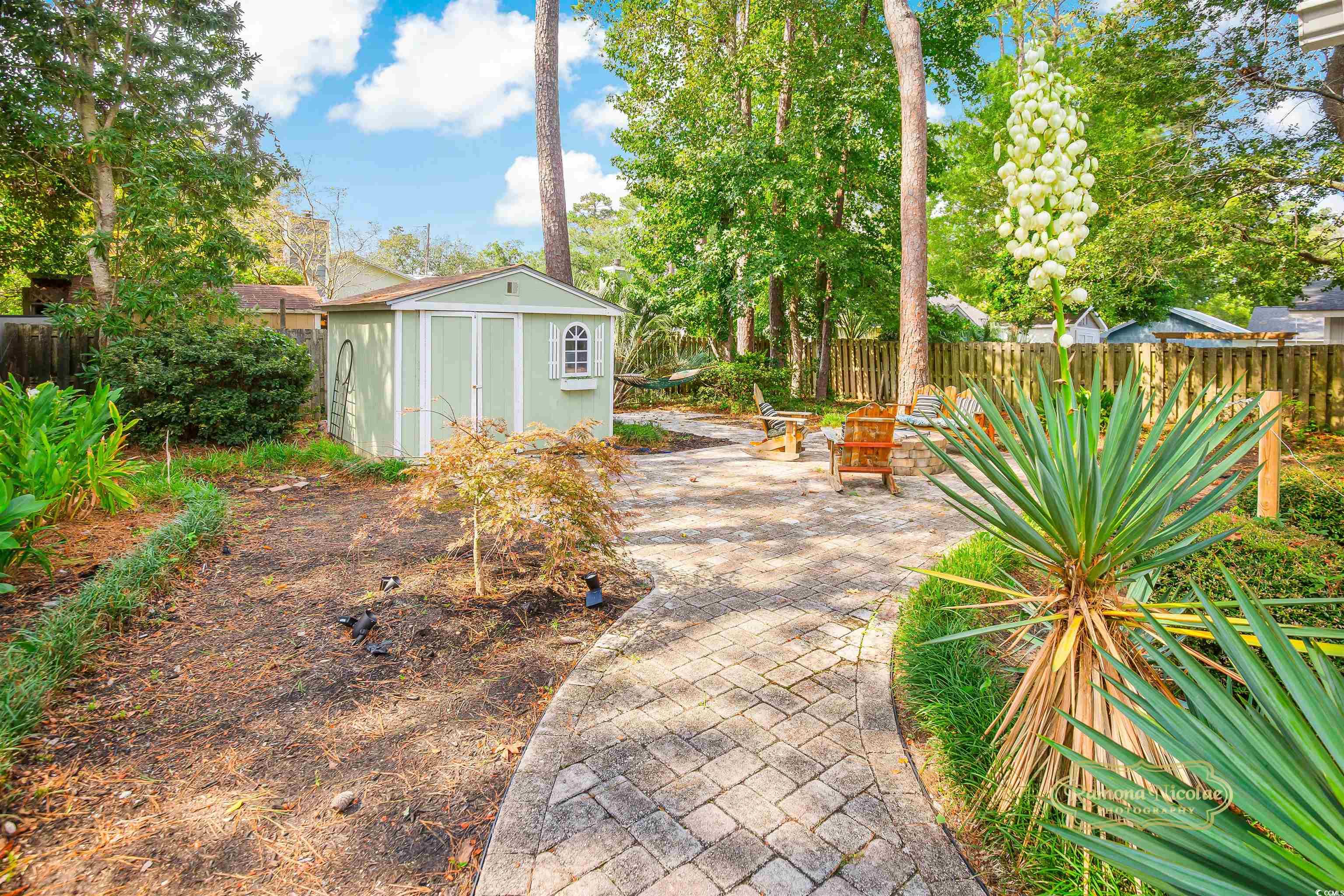 617 3rd Avenue South Surfside Beach, SC 29575 - Photo 32 of 36 Back of property featuring a fire pit and a patio
