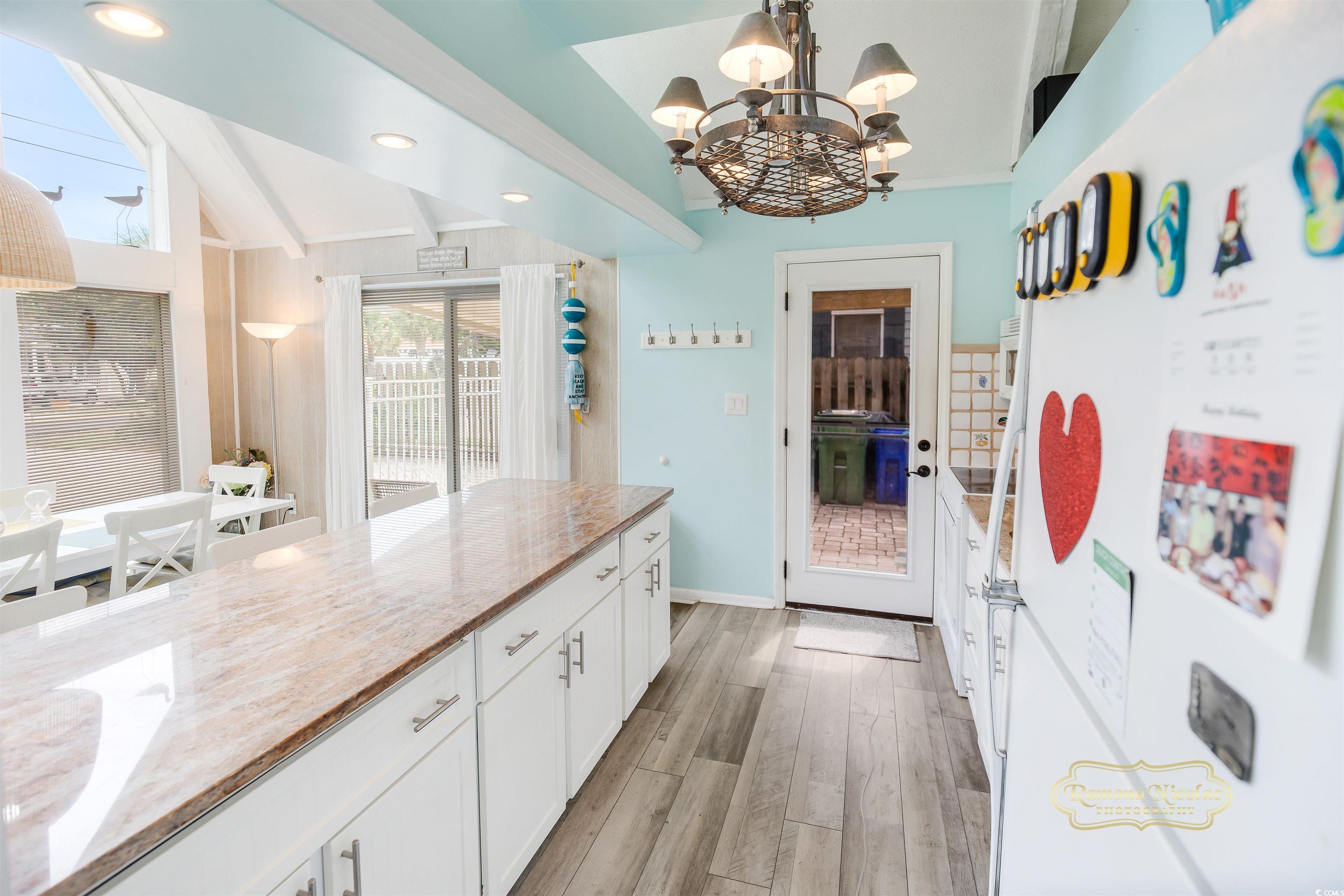 617 3rd Avenue South Surfside Beach, SC 29575 - Photo 10 of 36 Kitchen featuring light stone counters, vaulted ce