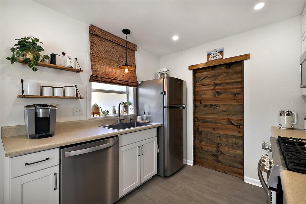 30 East Key Avenue Eustis, FL 32726 - Photo 11 of 32 a kitchen with stainless steel appliances a refrigerator sink and cabinets