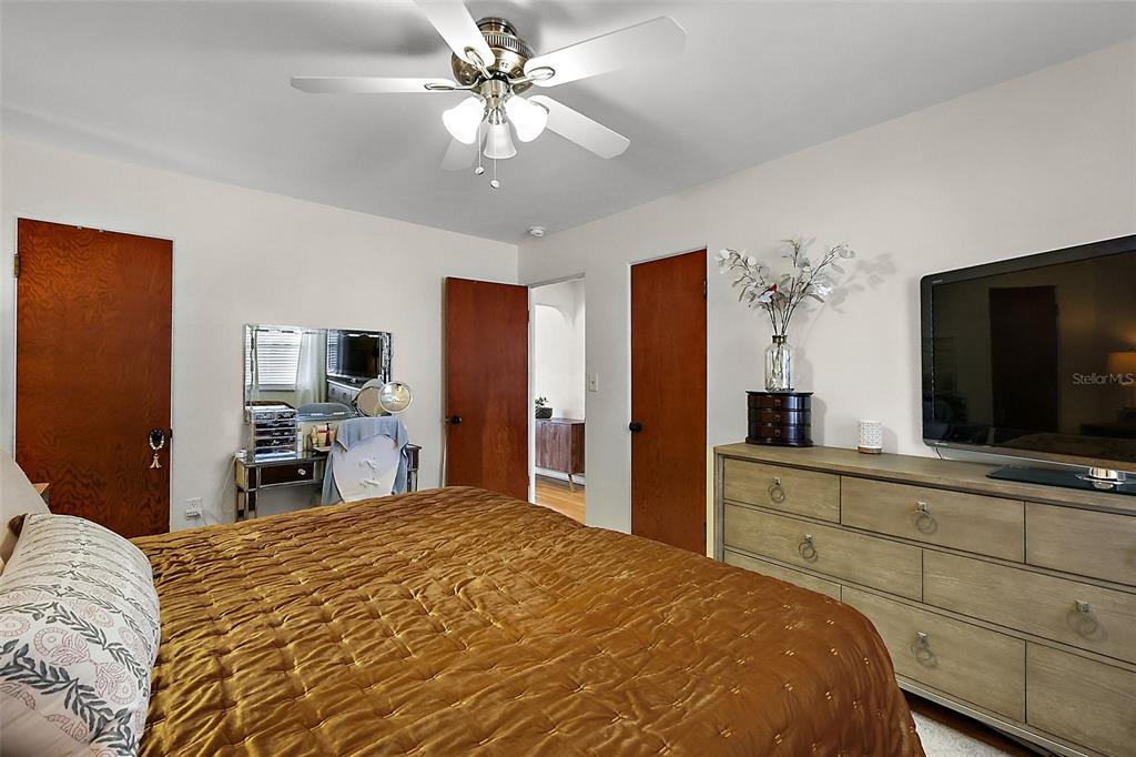 30 East Key Avenue Eustis, FL 32726 - Photo 19 of 32 a bedroom with a large bed and a flat tv screen on dresser