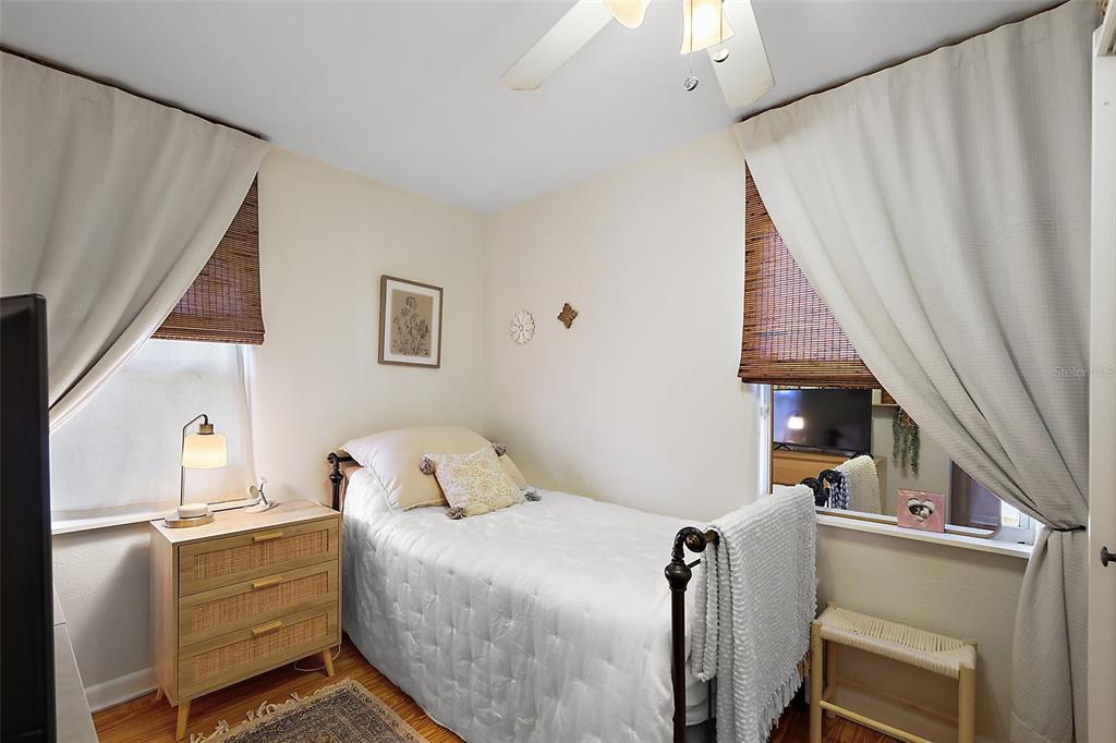 30 East Key Avenue Eustis, FL 32726 - Photo 21 of 32 a bedroom with a bed and wooden floor