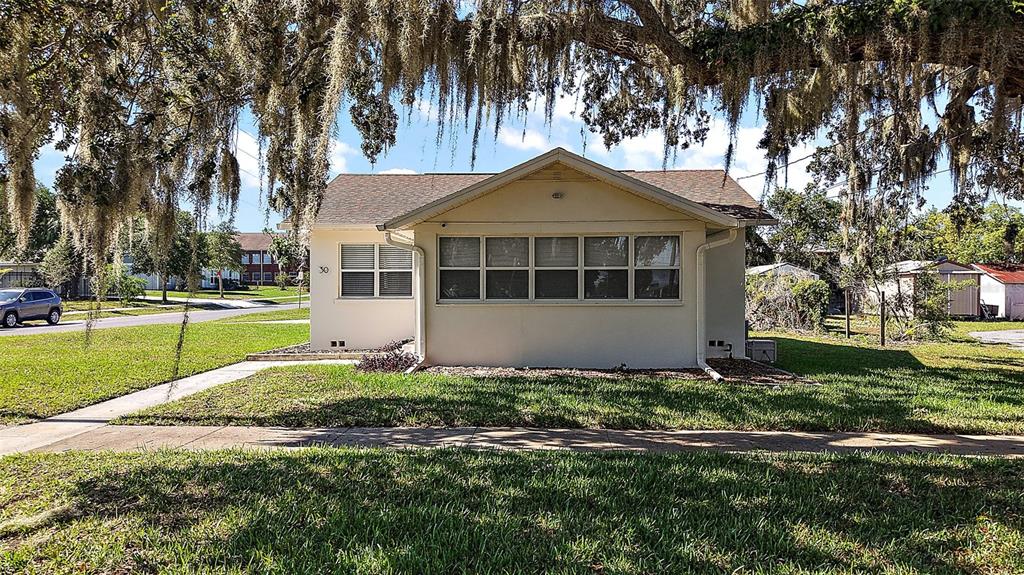 30 East Key Avenue Eustis, FL 32726 - Photo 29 of 32 a front view of a house with a yard