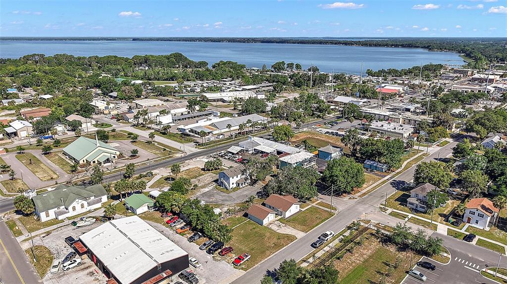 30 East Key Avenue Eustis, FL 32726 - Photo 31 of 32 an aerial view of a city with lots of residential buildings and ocean view in back