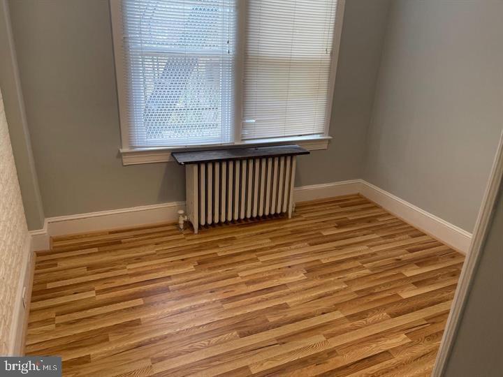 639 Plymouth Road, Unit A2 Baltimore, MD 21229 - Photo 11 of 14 a view of a room with wooden floor and a window