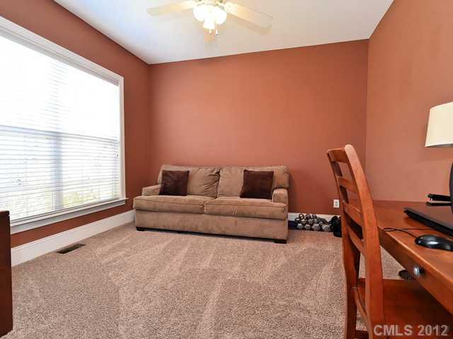 512 St Ives Court Fort Mill, SC 29708 - Photo 14 of 16 a living room with furniture a flat screen tv and a window