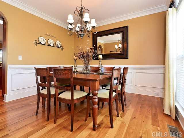 512 St Ives Court Fort Mill, SC 29708 - Photo 3 of 16 a view of a dining room with furniture wooden floor and a chandelier