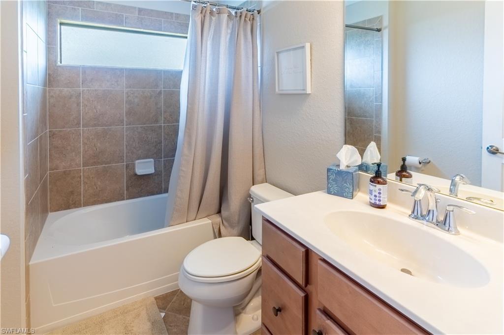 9521 Avellino Way, Unit 2426 Naples, FL 34113 - Photo 11 of 46 a bathroom with a sink a toilet and shower