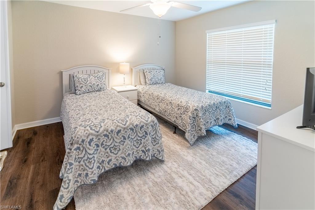 9521 Avellino Way, Unit 2426 Naples, FL 34113 - Photo 12 of 46 a bedroom with two beds and painting on the wall