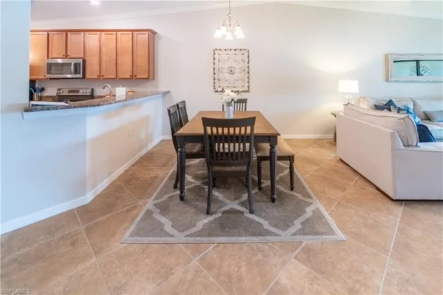 a dining room with furniture and a chandelier
