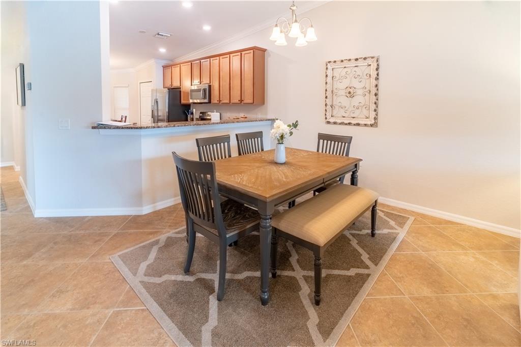 9521 Avellino Way, Unit 2426 Naples, FL 34113 - Photo 16 of 46 a view of a dining room with furniture