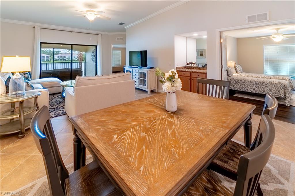 9521 Avellino Way, Unit 2426 Naples, FL 34113 - Photo 18 of 46 a view of a dining room with furniture