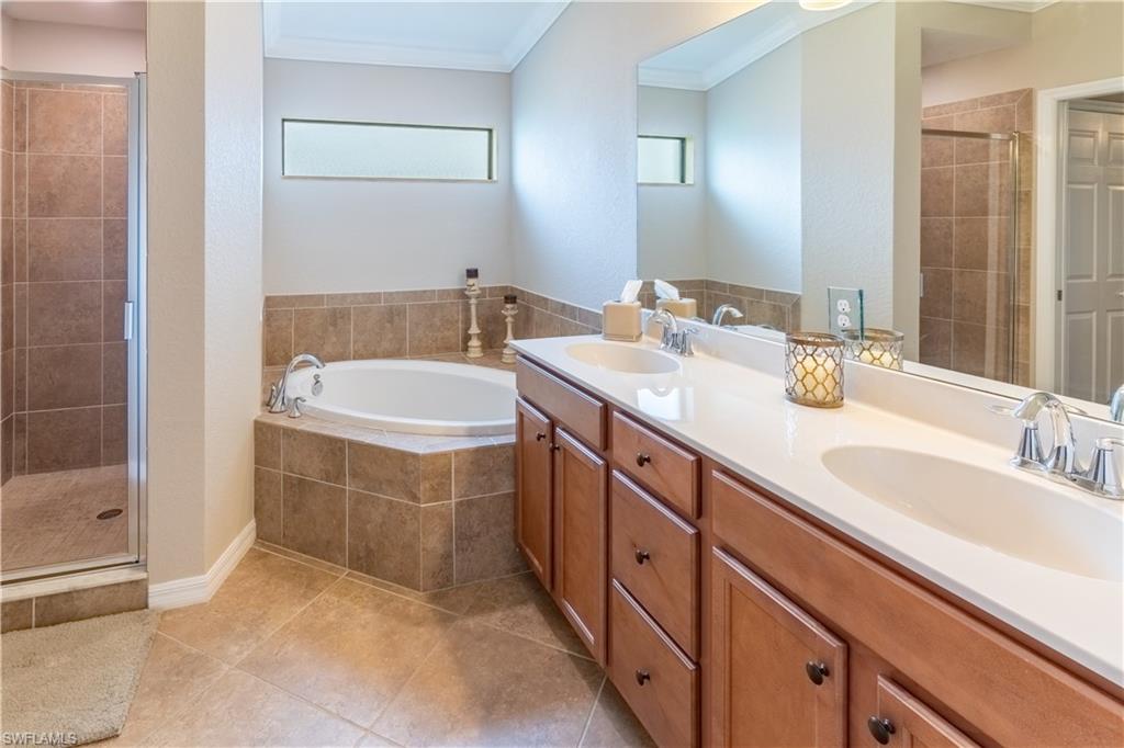 9521 Avellino Way, Unit 2426 Naples, FL 34113 - Photo 23 of 46 a spacious bathroom with a sink and a mirror