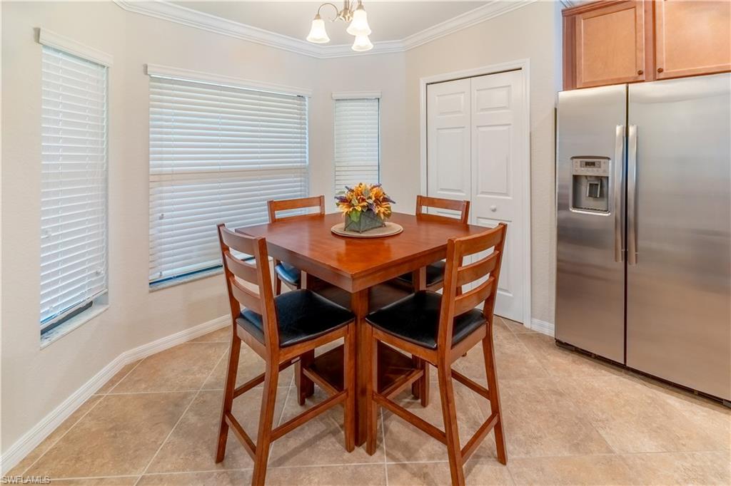 9521 Avellino Way, Unit 2426 Naples, FL 34113 - Photo 5 of 46 a dining room with furniture and window