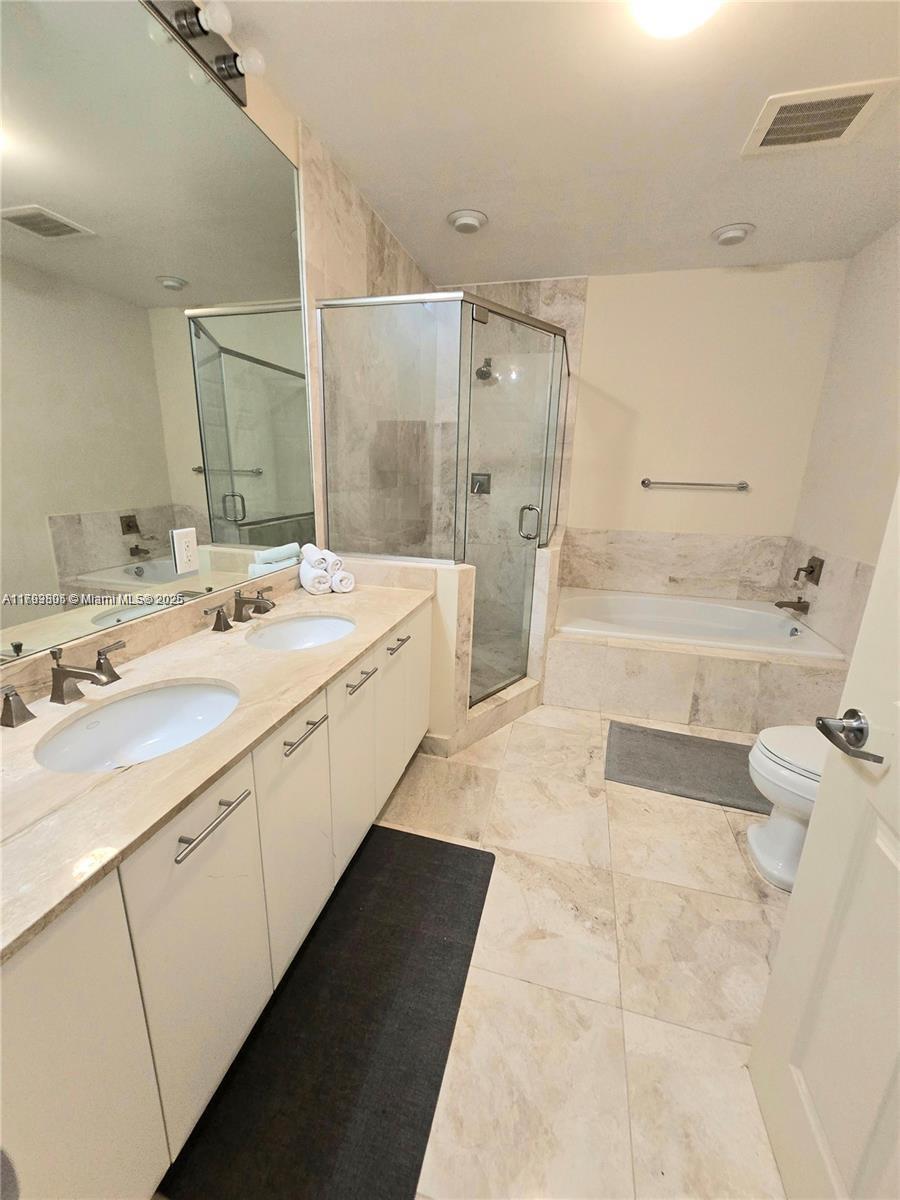 510 Northwest 84th Avenue, Unit 121 Plantation, FL 33324 - Photo 19 of 39 a spacious bathroom with a bathtub shower sink mirror and toilet