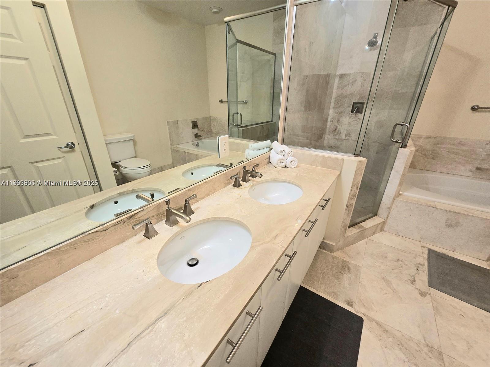 510 Northwest 84th Avenue, Unit 121 Plantation, FL 33324 - Photo 20 of 39 a bathroom with a double vanity sink and a mirror