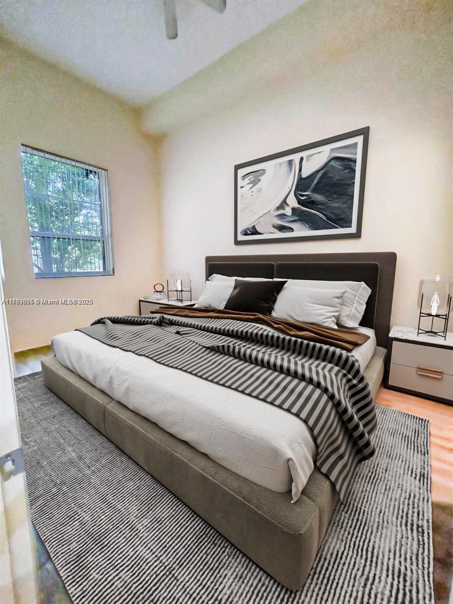 510 Northwest 84th Avenue, Unit 121 Plantation, FL 33324 - Photo 25 of 39 a bedroom with a bed and a painting on the wall