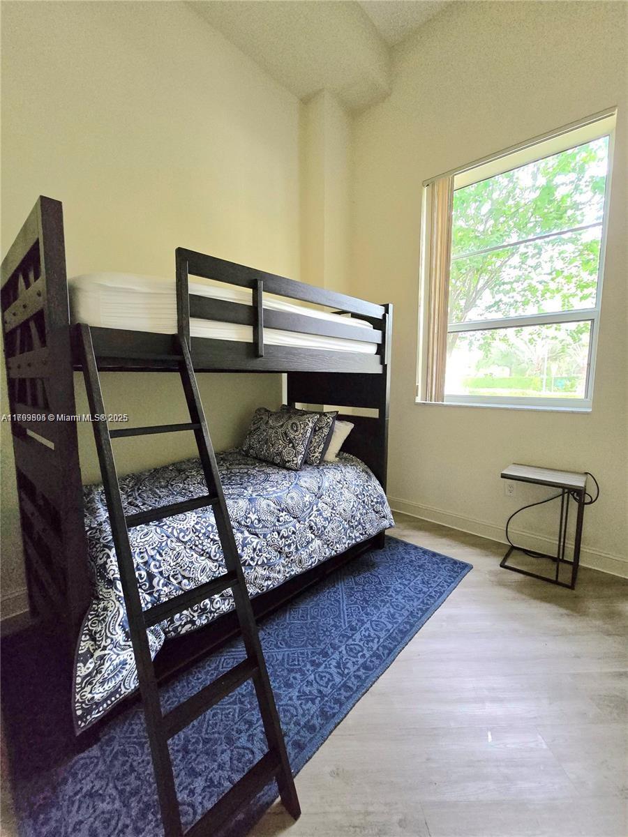 510 Northwest 84th Avenue, Unit 121 Plantation, FL 33324 - Photo 26 of 39 a bedroom with a bed chair and wall