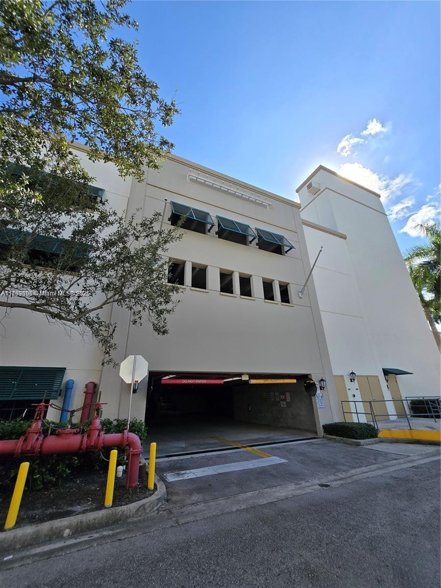 510 Northwest 84th Avenue, Unit 121 Plantation, FL 33324 - Photo 31 of 39 a front view of a house with a garage