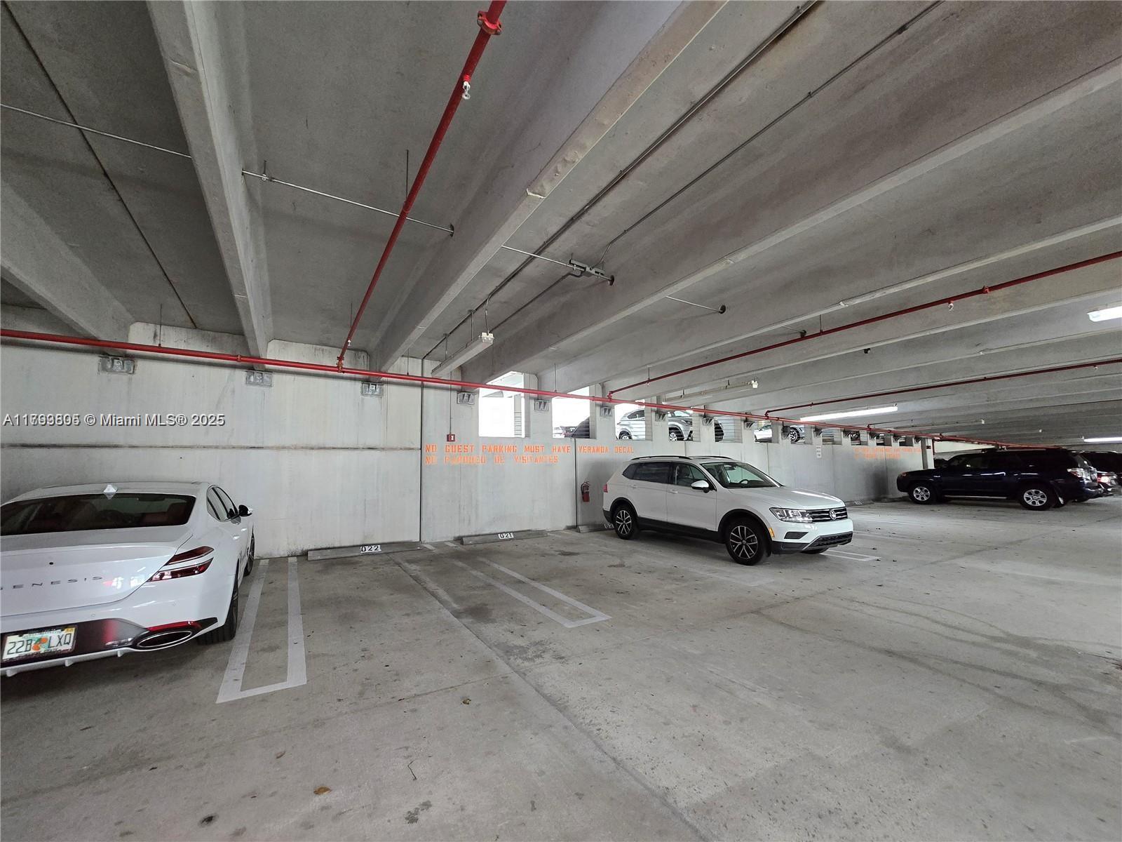 510 Northwest 84th Avenue, Unit 121 Plantation, FL 33324 - Photo 32 of 39 a view of parking garage with cars parked