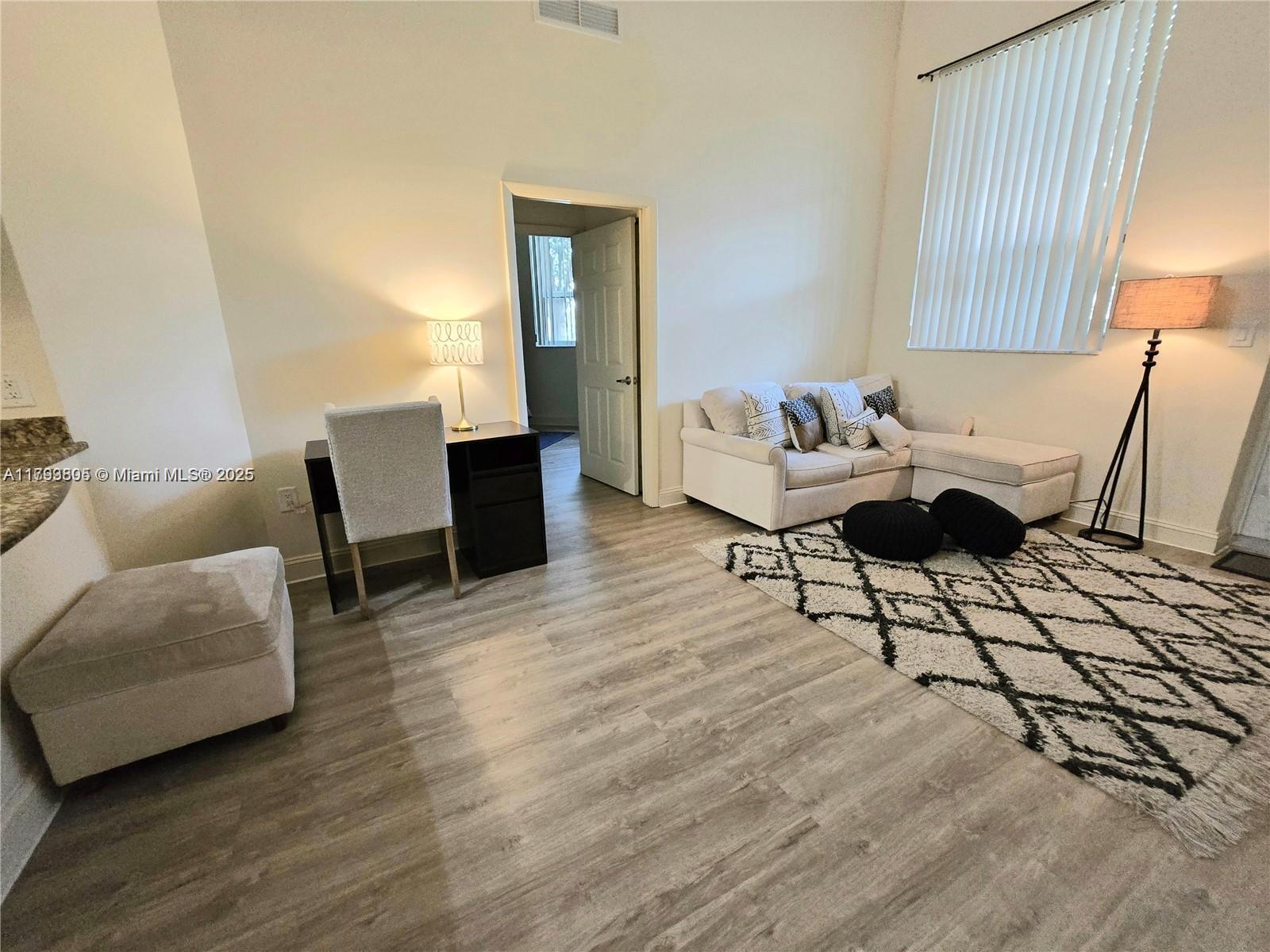 510 Northwest 84th Avenue, Unit 121 Plantation, FL 33324 - Photo 8 of 39 a living room with furniture and a table