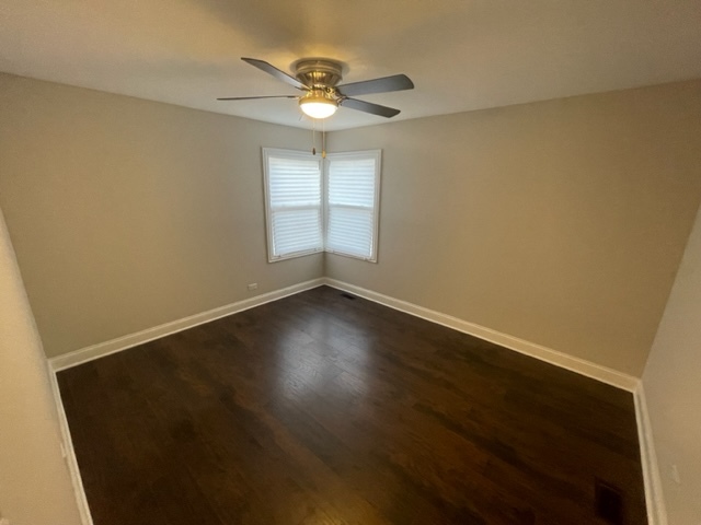 2814 Lexington Drive Hazel Crest, IL 60429 - Photo 5 of 10 an empty room with wooden floor fan and windows